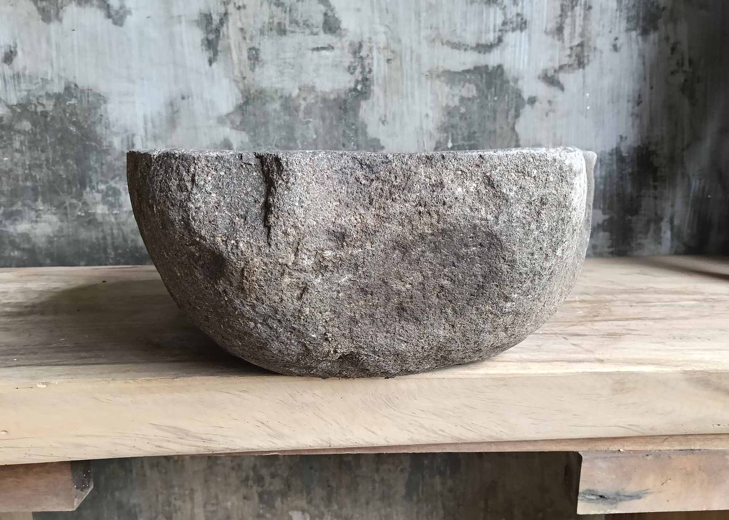 Left side view of river stone sink SKU 6007-5338 with organic shape and rough textured exterior surface