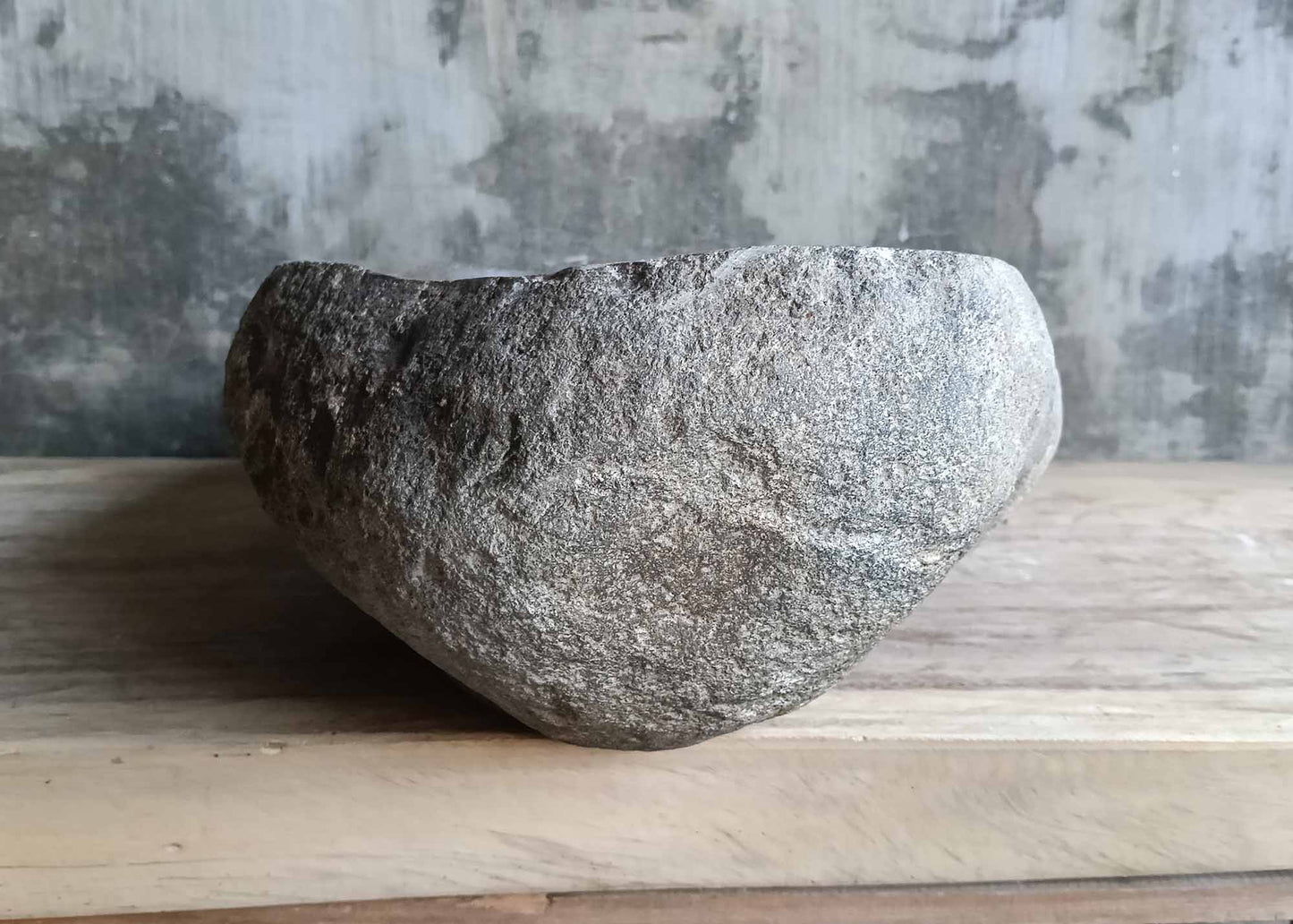 Left side view of river stone sink SKU 6046-5534 with organic shape and rough textured exterior