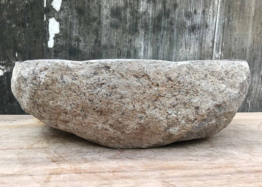 Backside of river stone sink 6075-4733 with raw stone exterior and natural curves