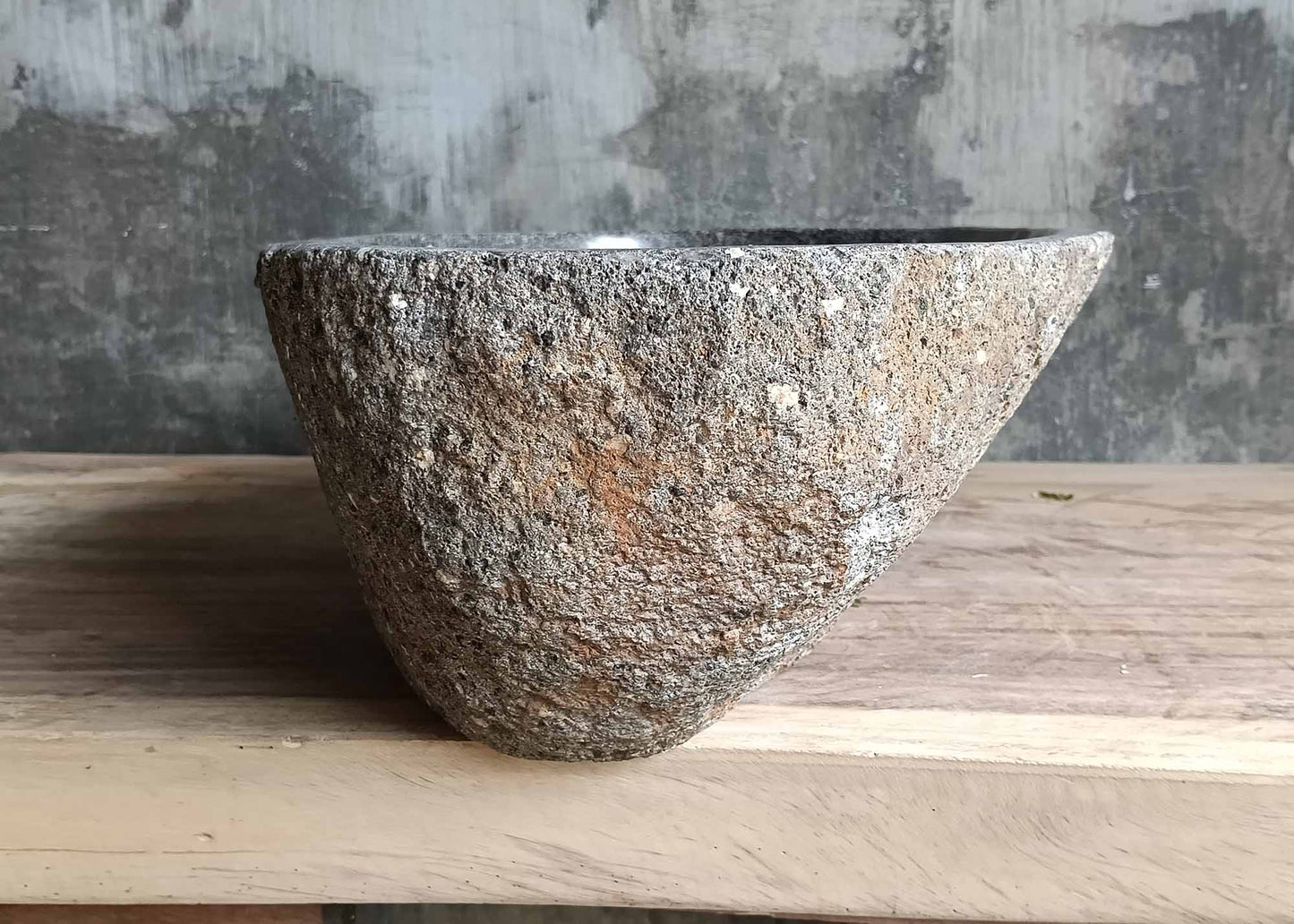 Left side view of oval river stone sink SKU 6083-5335 with natural uneven stone exterior and polished interior finish