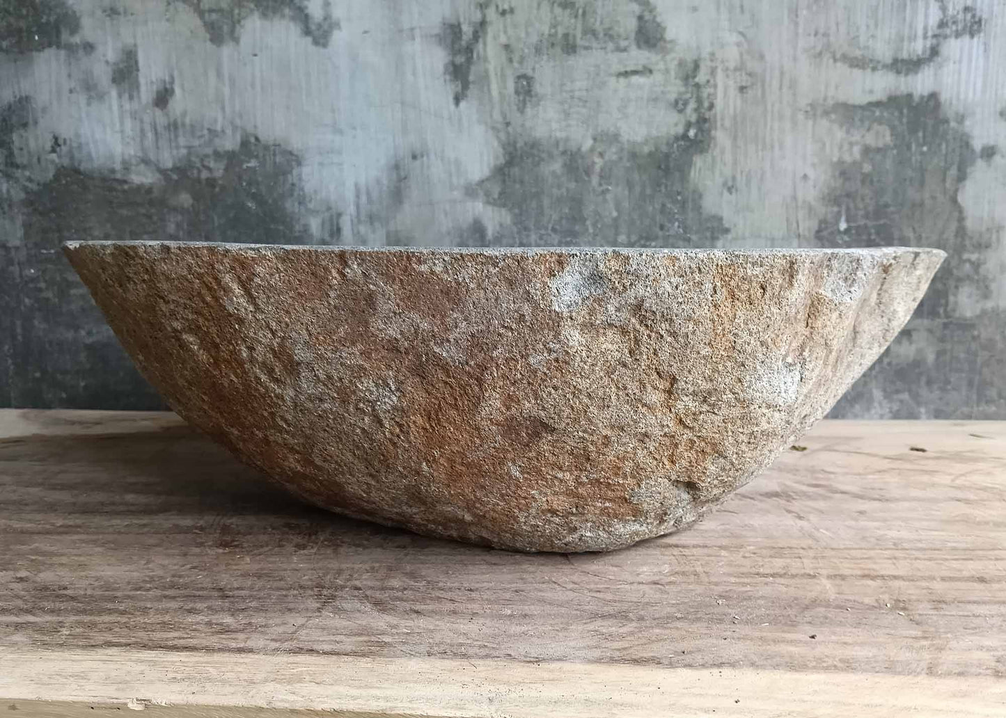 Backside of river stone sink 6093-4937 with raw stone texture and triangular shape