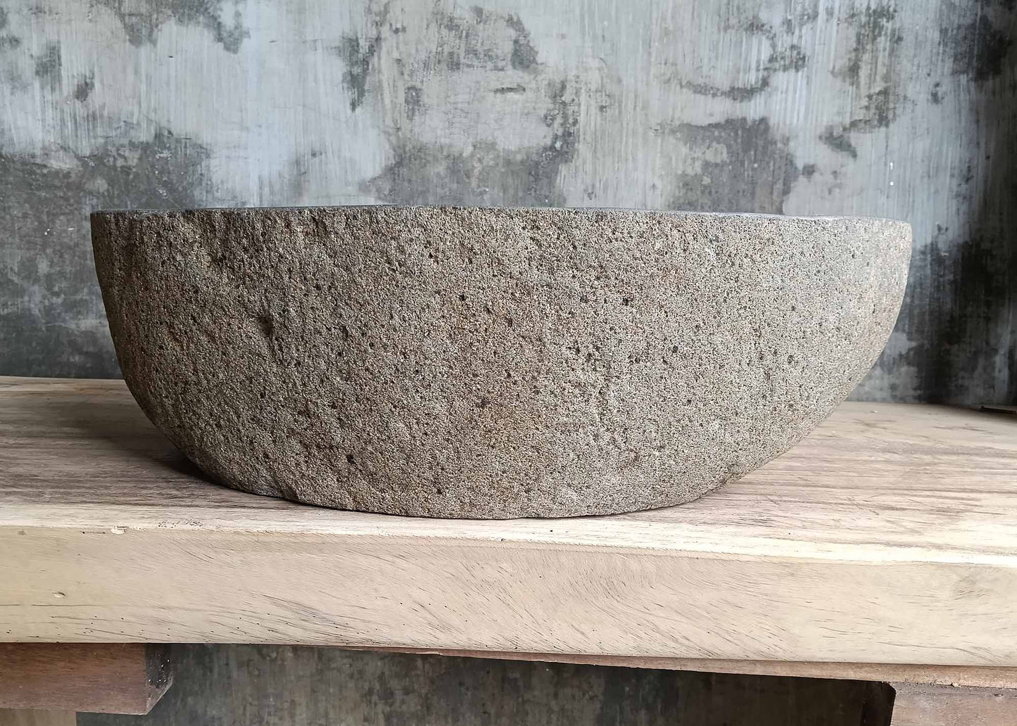 Rear view of oval river stone sink SKU 6116-5032 highlighting rough natural stone texture and smooth polished basin
