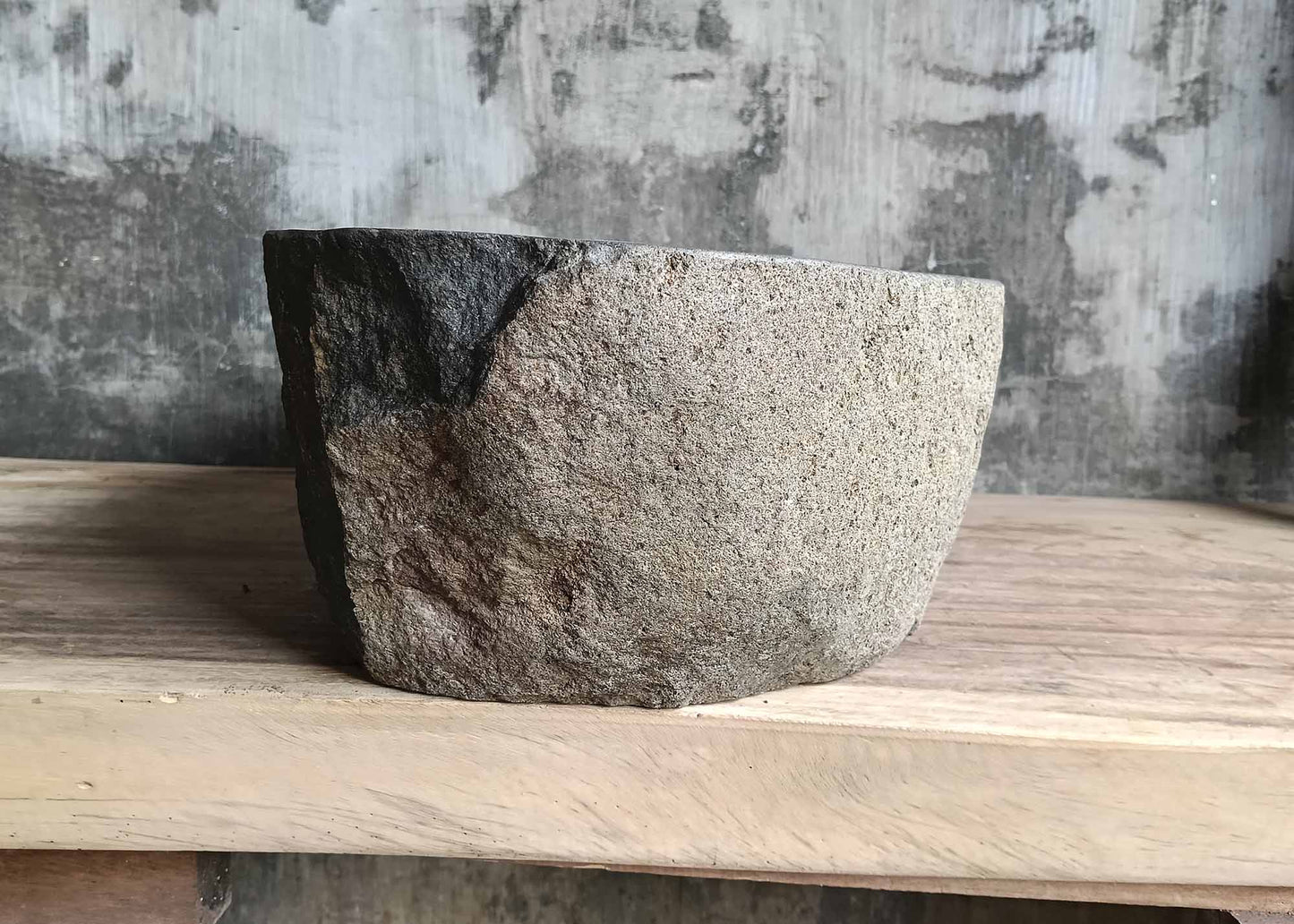 Right side view of handcrafted oval dark gray river stone sink SKU 6116-5032 with rugged exterior and polished interior surface