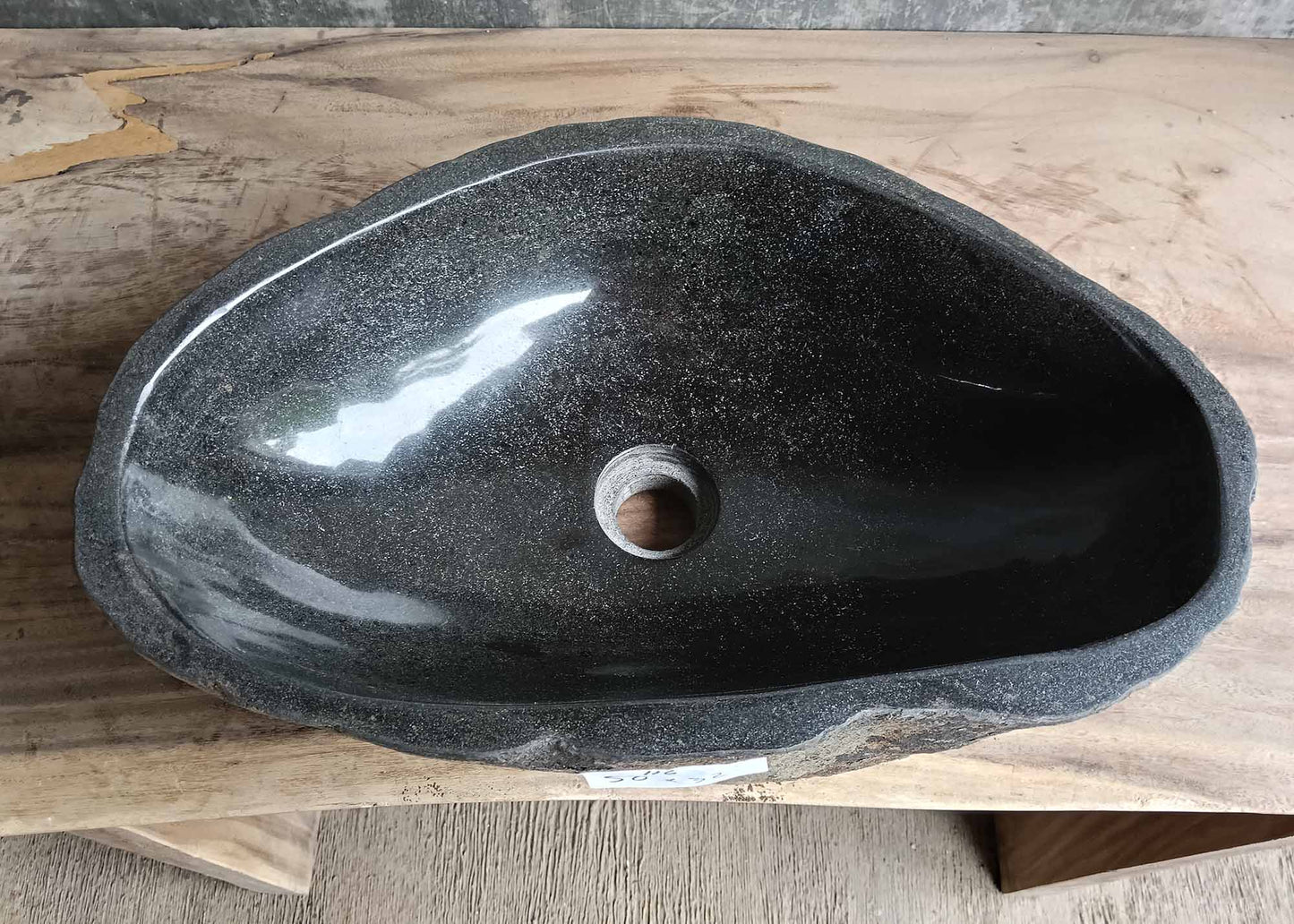 Top view of handcrafted oval dark gray river stone sink SKU 6116-5032 with polished interior and natural rough exterior texture