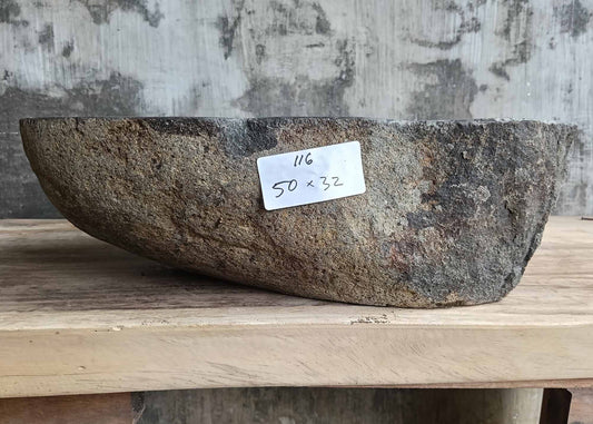 Front view showing natural rugged dark gray stone exterior of river stone sink SKU 6116-5032 with organic oval shape