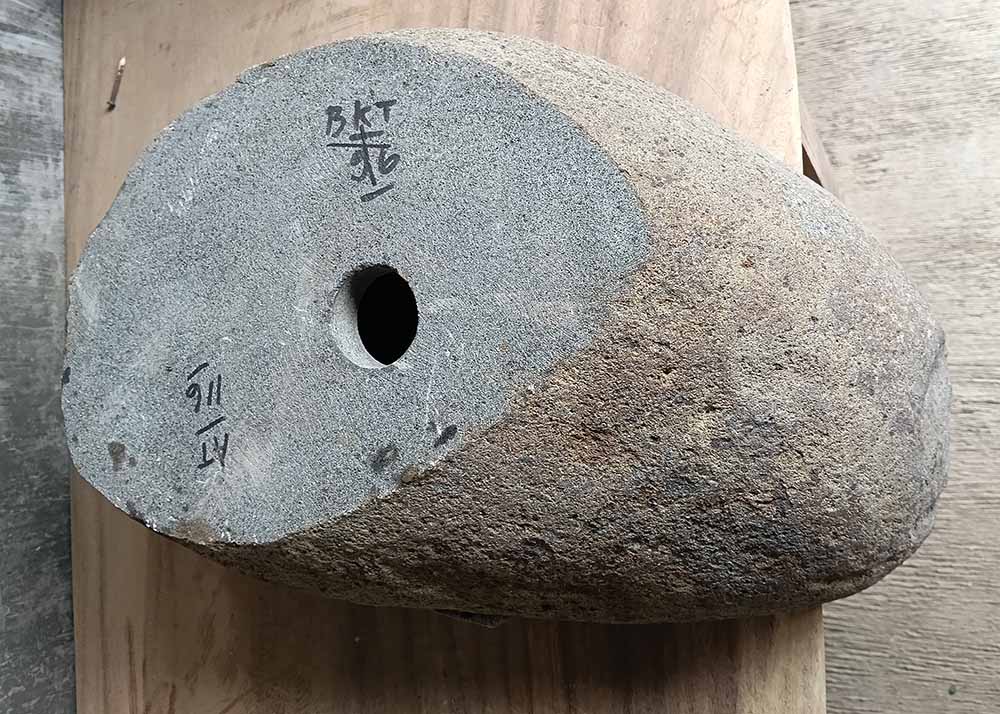 Bottom view showing natural unfinished stone base of handcrafted oval river stone sink SKU 6116-5032