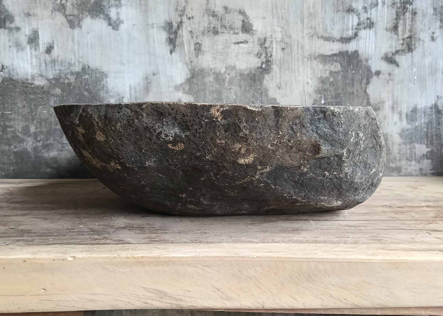 Rear view of river stone sink SKU 6160-5141 featuring raw boulder texture and elongated oval body