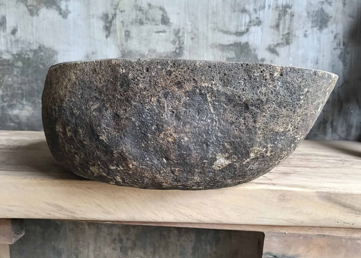 Left side of river stone sink SKU 6160-5141 with natural textured stone and smooth curved lines