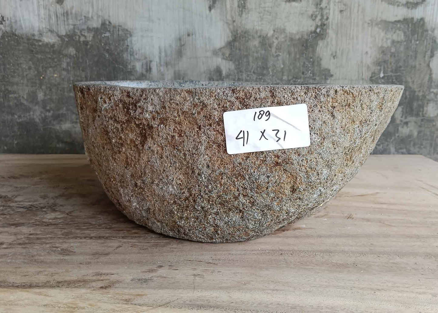 Right side of 16×12 inch river stone sink showing stone grain and boat contour