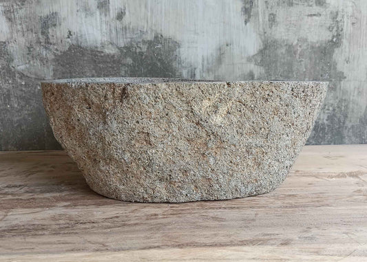 Front side of 16×12 inch handcrafted river stone sink with gray raw exterior and boat-like silhouette