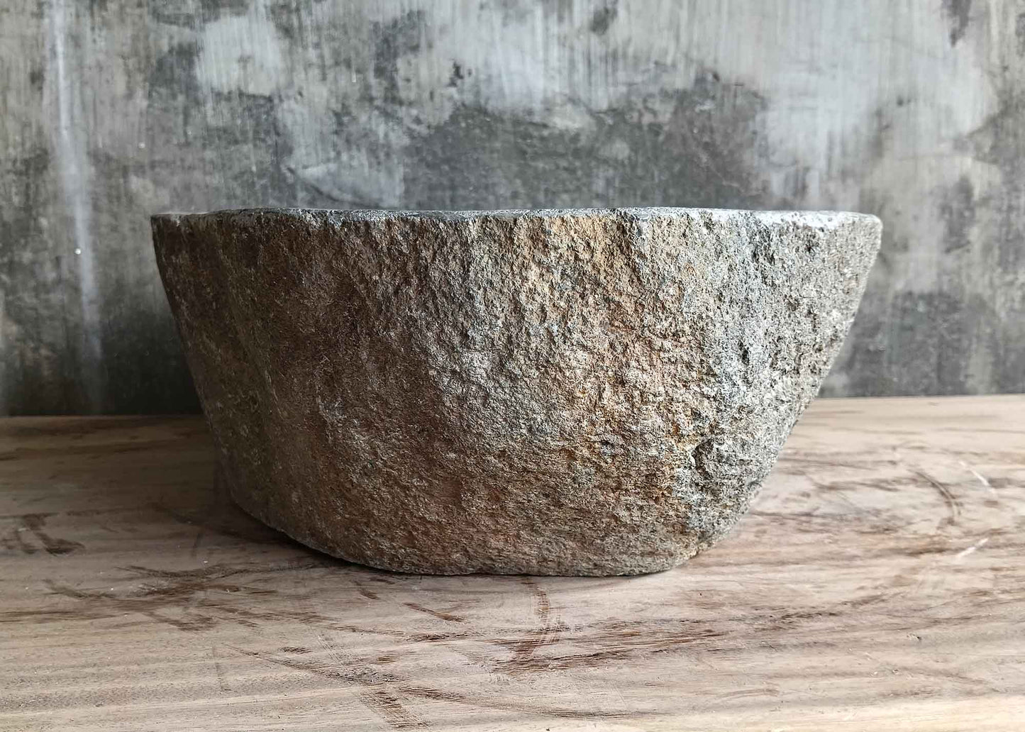 Left side view of handcrafted 17×13 inch stone sink with boat profile and raw stone finish