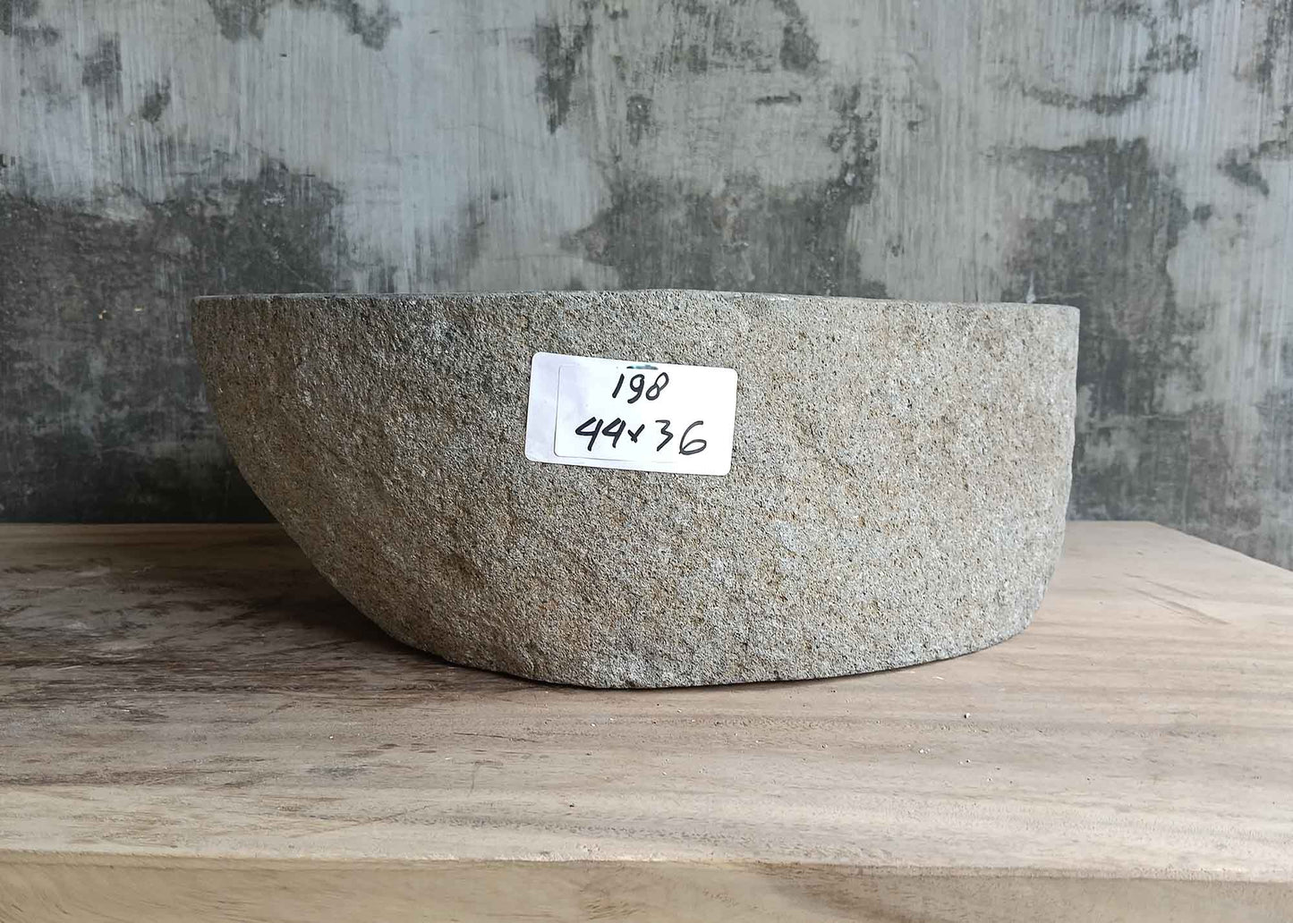 Left side of 17×14 inch gray river stone sink with vertical cylindrical outer wall