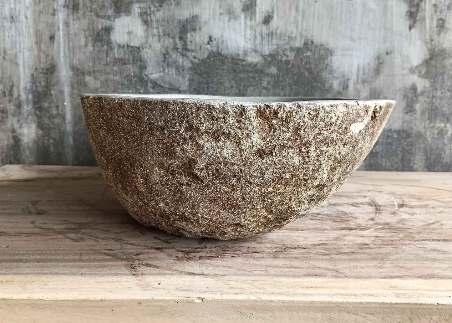 Left side of 17×14 inch handcrafted river stone sink with symmetrical oval profile