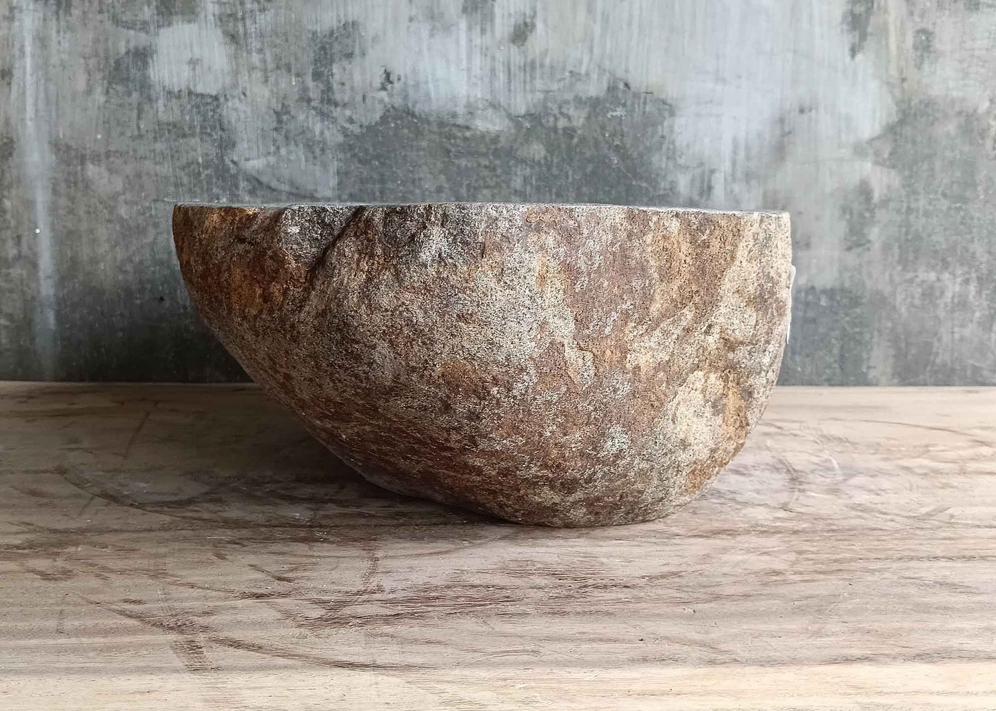 Left side view of 16×13 inch gray river stone sink with smooth interior and oval profile