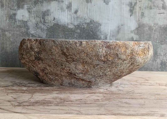 Front view of 16×13 inch gray oval river stone sink with raw outer texture