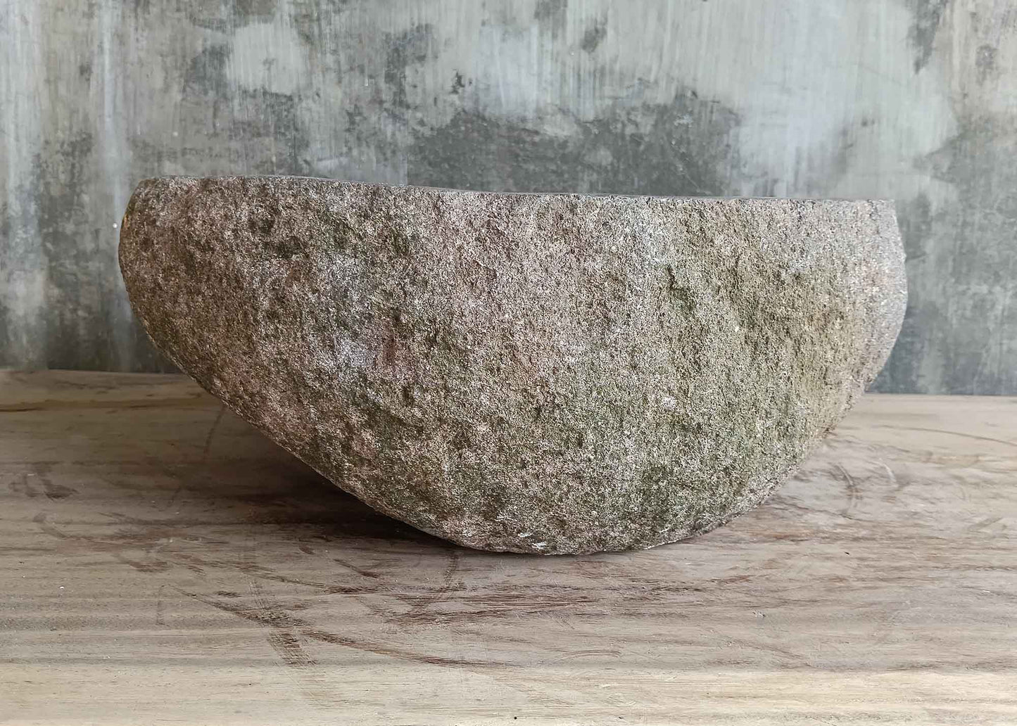 Right side of handcrafted 16×13 inch stone sink with contrasting polished and rough surfaces