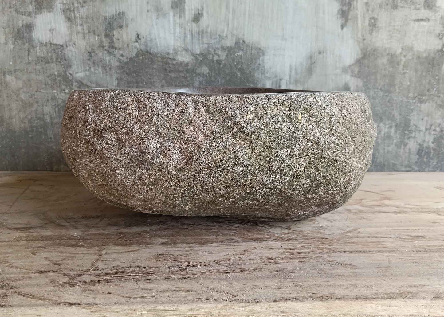 Back view of 16×13 inch river stone sink showing natural brown texture and curved oval form