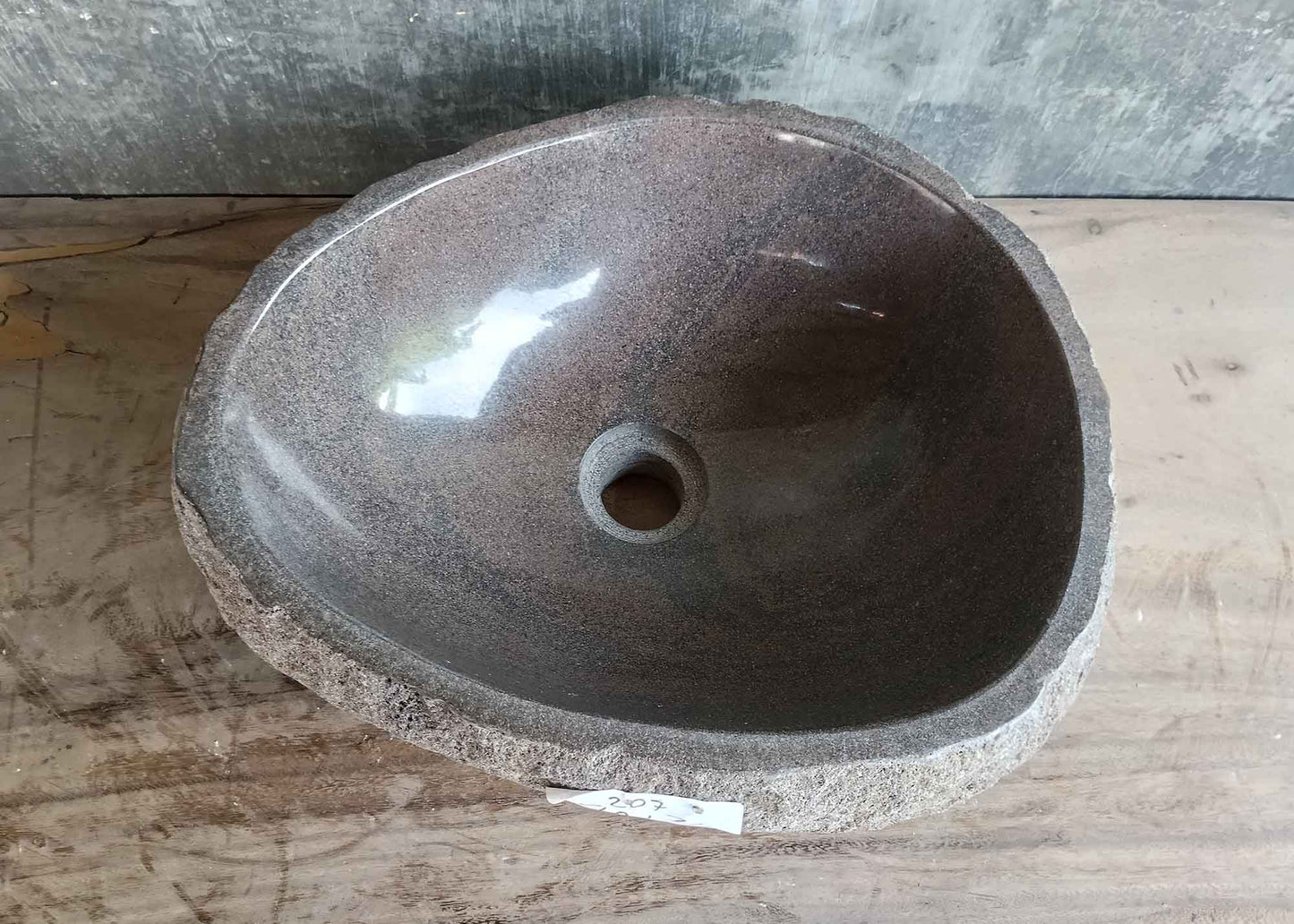 Top view of 16×13 inch brown river stone sink with polished volcanic interior and oval shape