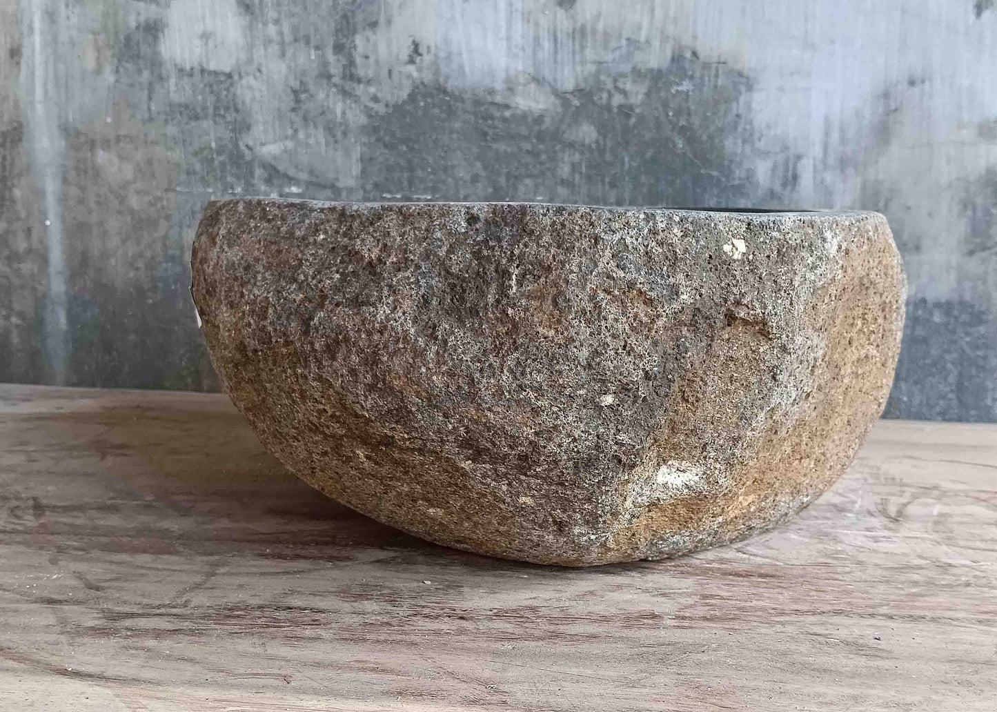 Left side view of 13×13 inch grey-brown river stone sink installed in countertop