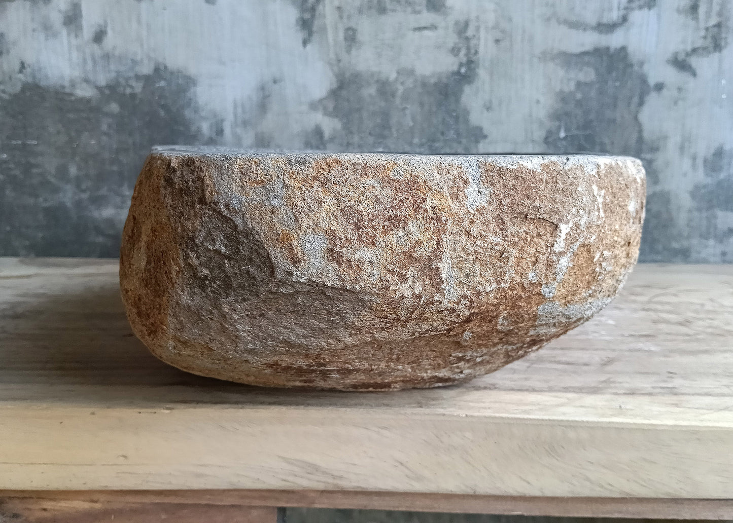Right view of 48x33 cm stone sink with curved lines and raw stone texture
