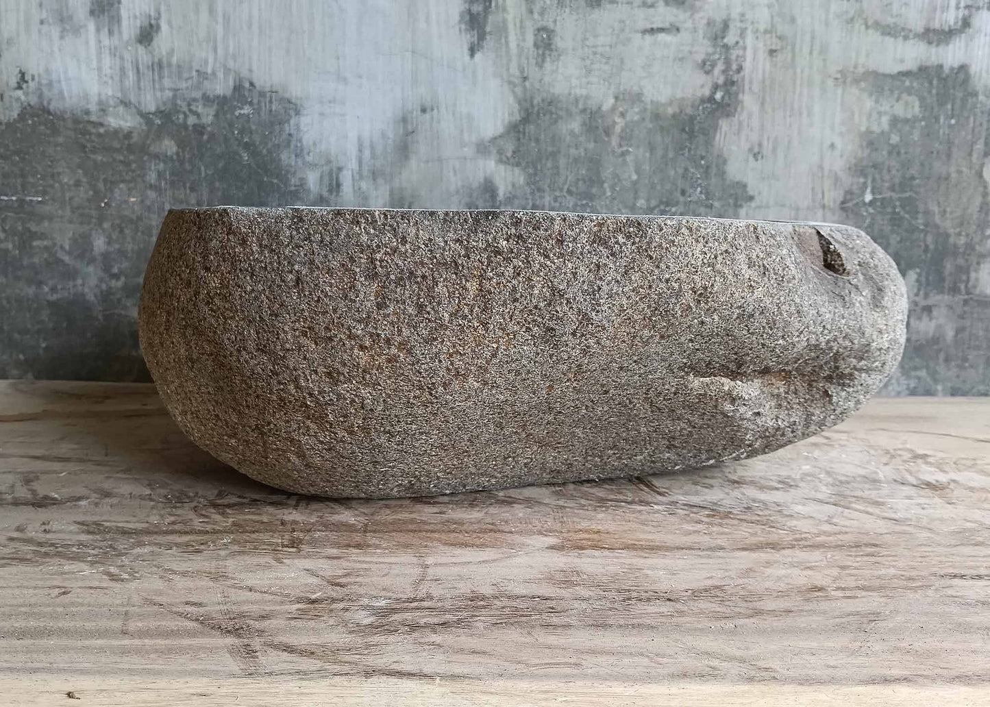 Back view of handcrafted triangular river stone sink
