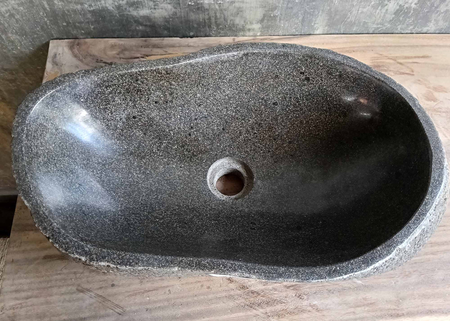 Top view of river stone sink 6275-5230 with dark polished oval bowl and natural texture