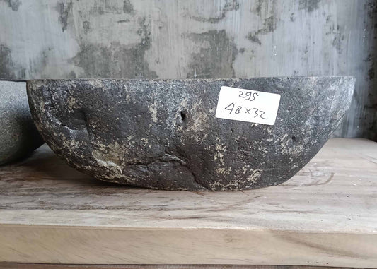 Front profile of handcrafted dark stone sink with oval shape