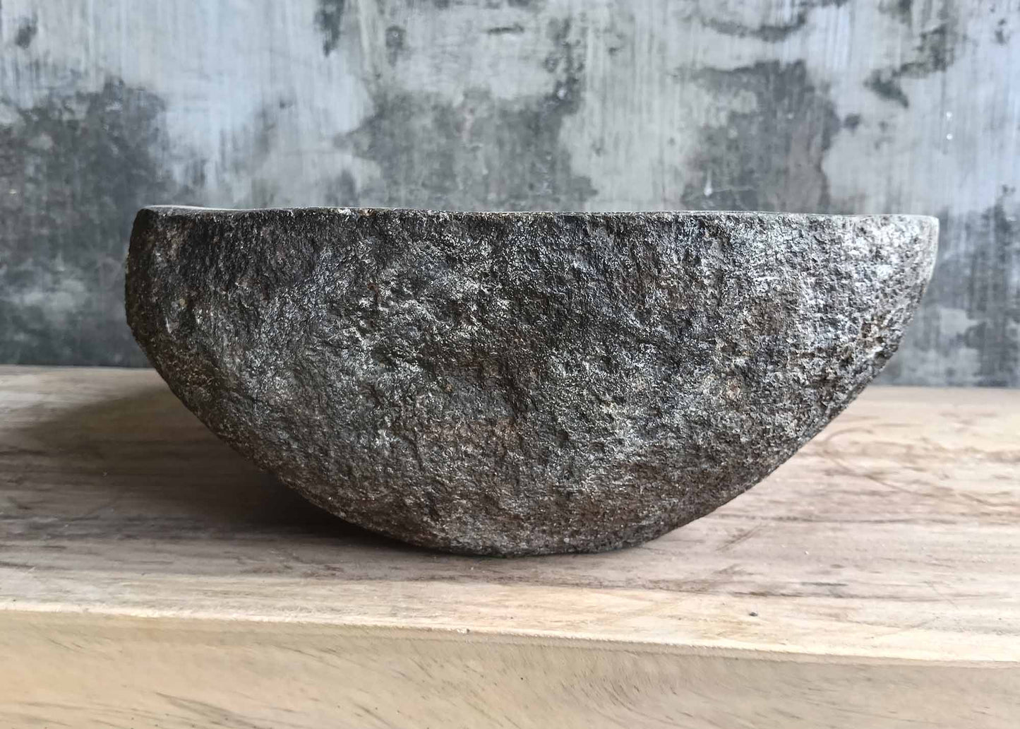 Back side of deep gray handcrafted river stone basin