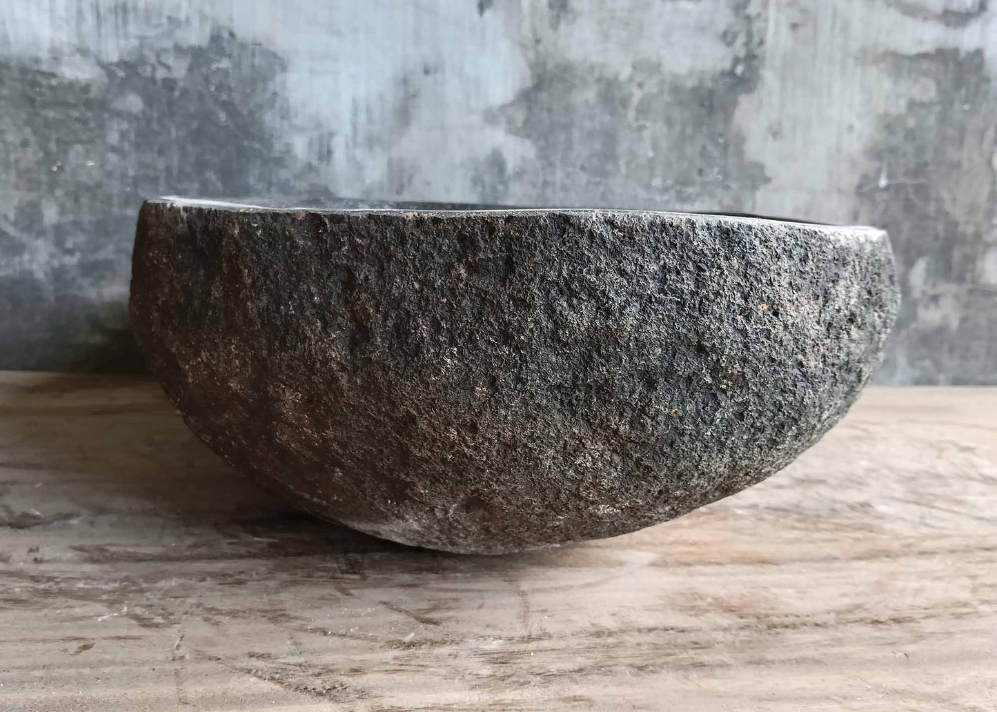Left angle showing dark textured stone sink exterior