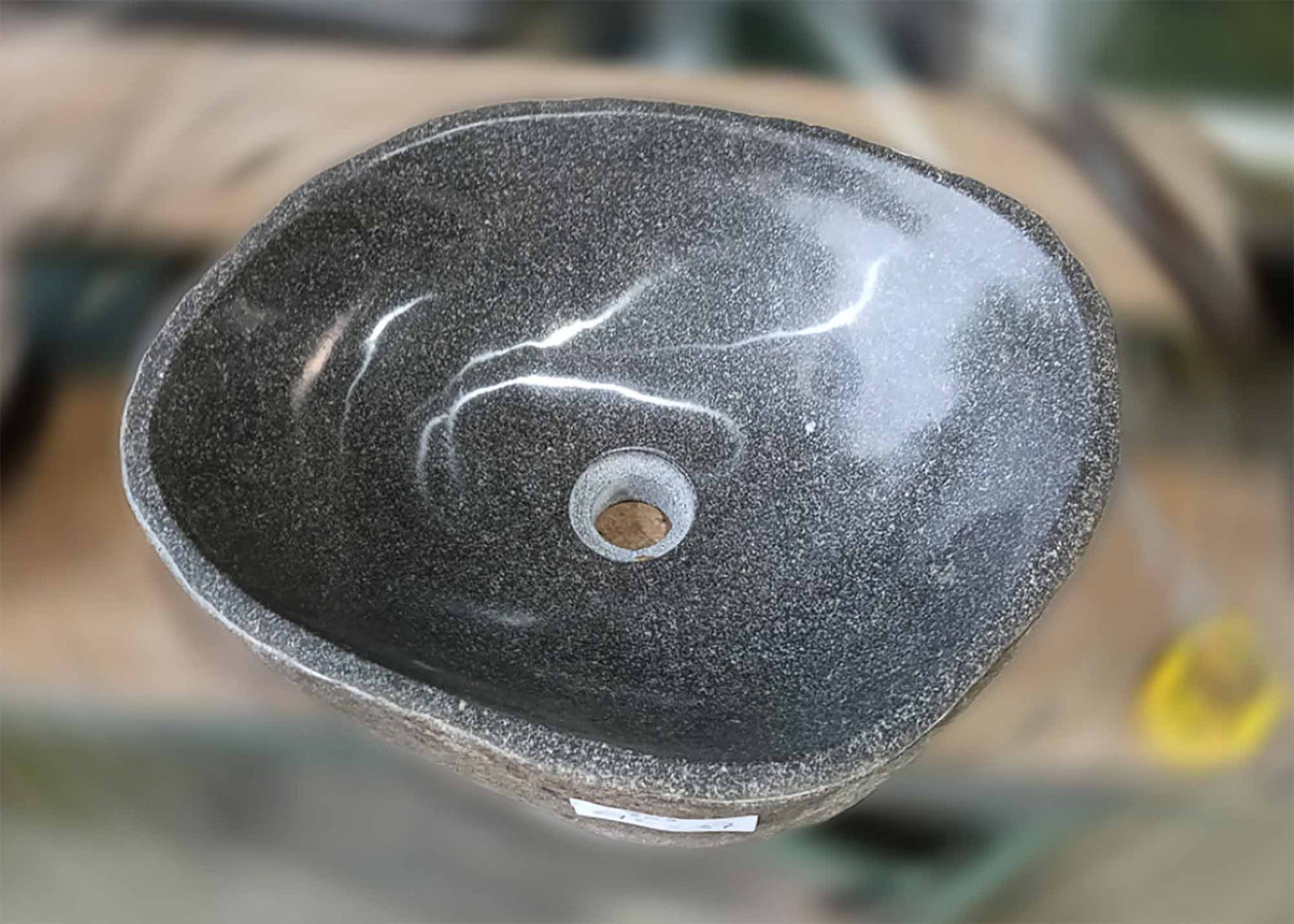 Top view of handcrafted gray river stone sink with irregular opening