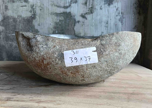 Right side view of 15×15 inch river stone sink installed in countertop, showing irregular form