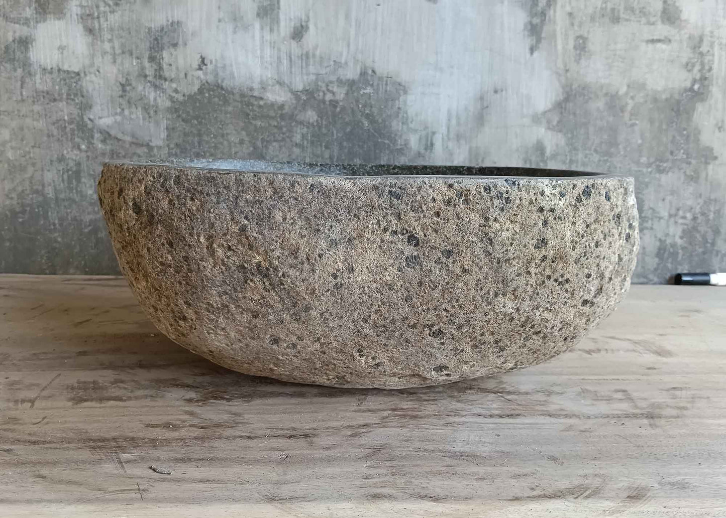 Left side view of 15×12 inch gray river stone sink in oval boat shape
