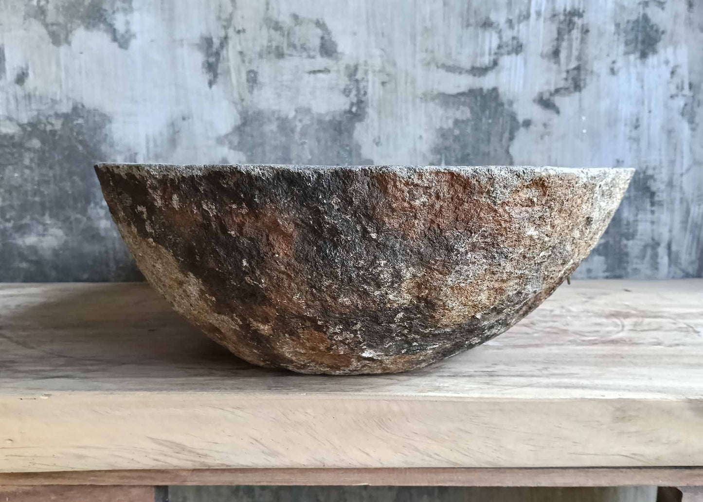 Right side view of stone sink 6241-6342 with smooth oval bowl and rough stone base
