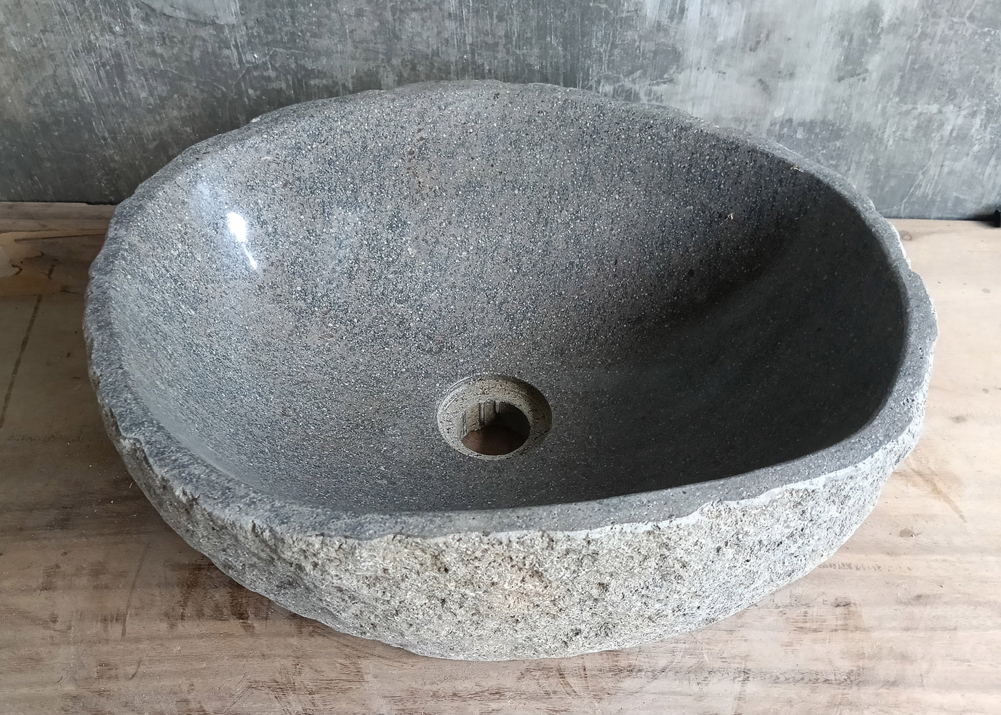 Back view of river rock basin with consistent gray tone and natural porous finish