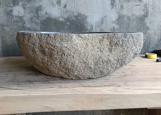 Front view of handcrafted gray basin with boat-style curve and natural texture