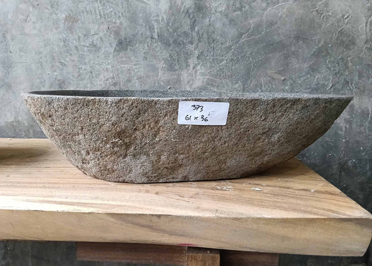 Front profile of handcrafted sink 6373-6136 with natural raw stone texture and flowing lines