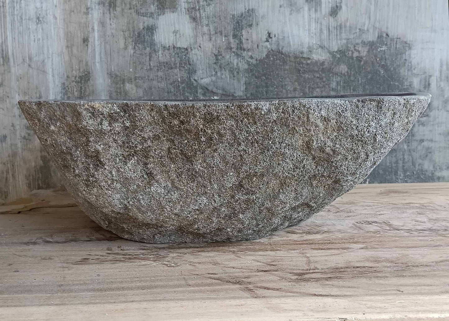 Front view of handcrafted river stone sink in rugged gray texture