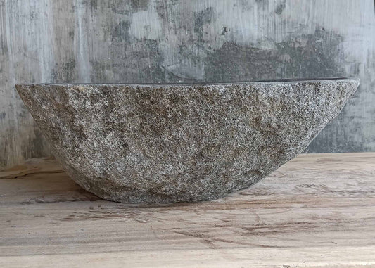 Front view of handcrafted river stone sink in rugged gray texture