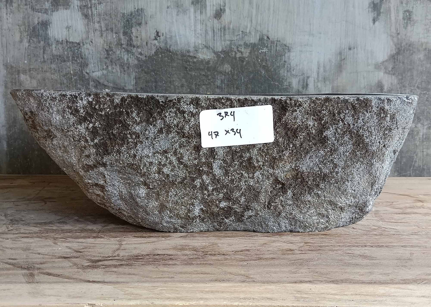Side profile showing raw natural stone shape of the sink