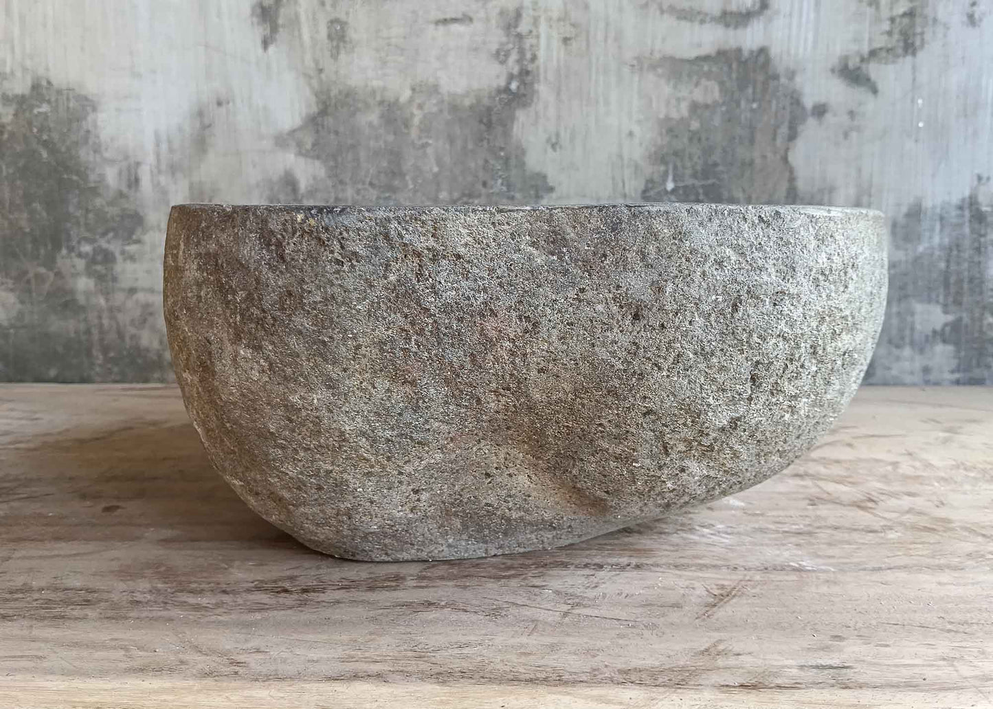 Back view of 12×12 inch round dark gray river stone sink with textured stone finish