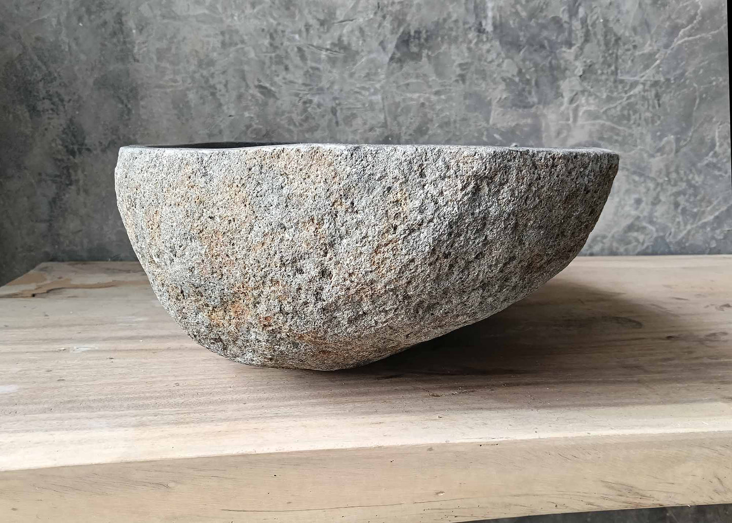 Earthy texture handcrafted river stone sink – left side view