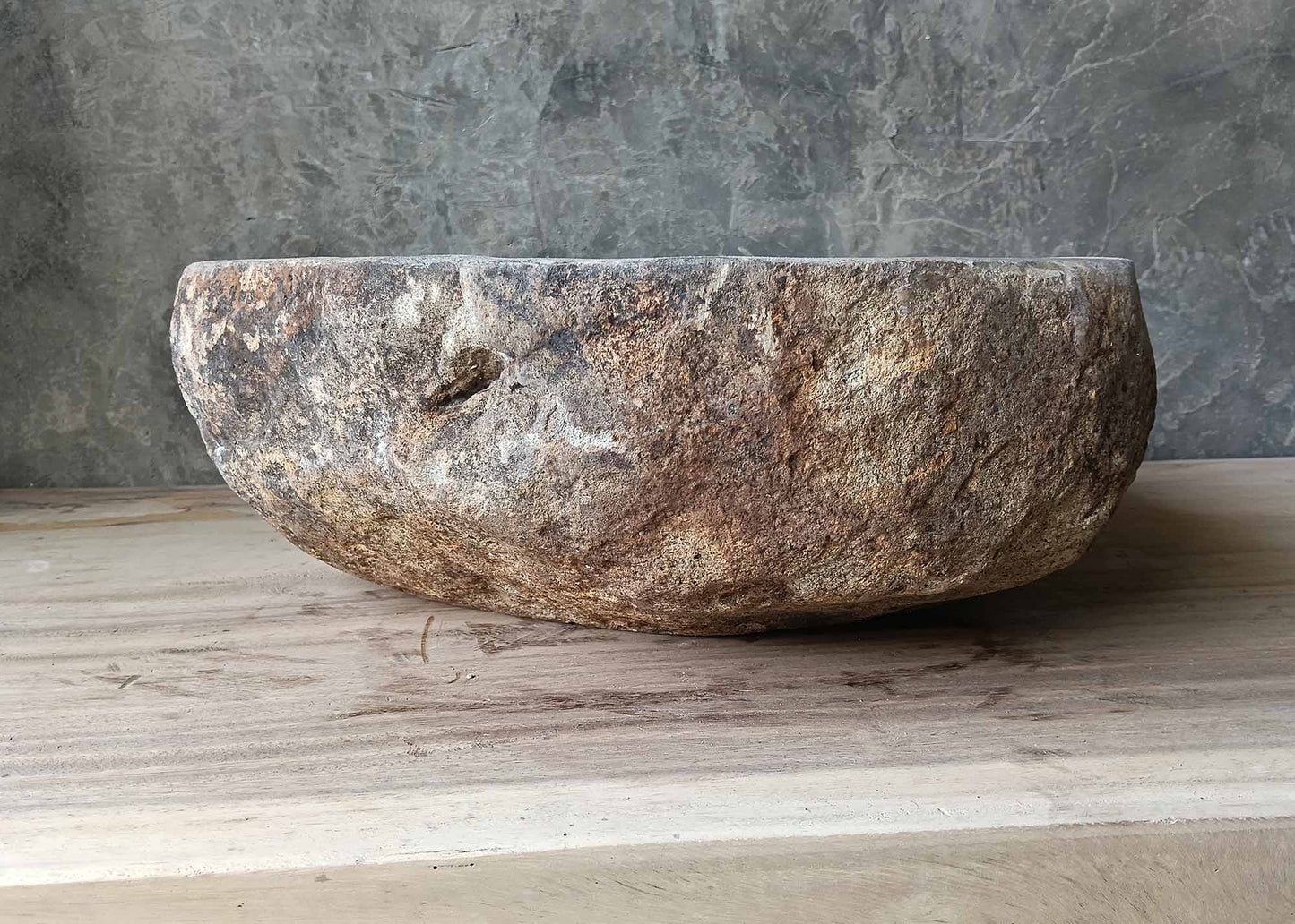 Raw textured river stone sink with earth tones – left side view
