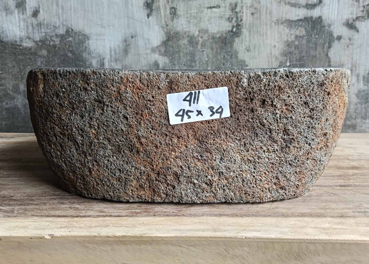 Front view of natural river stone sink with textured volcanic-style surface and rustic tones