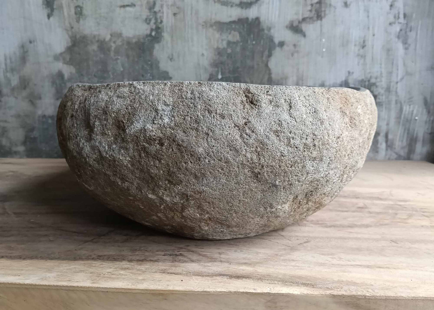 Right edge of asymmetrical stone sink with earthy color variations