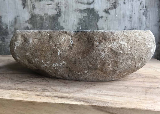 Front profile of natural stone sink showing warm beige and rust tones