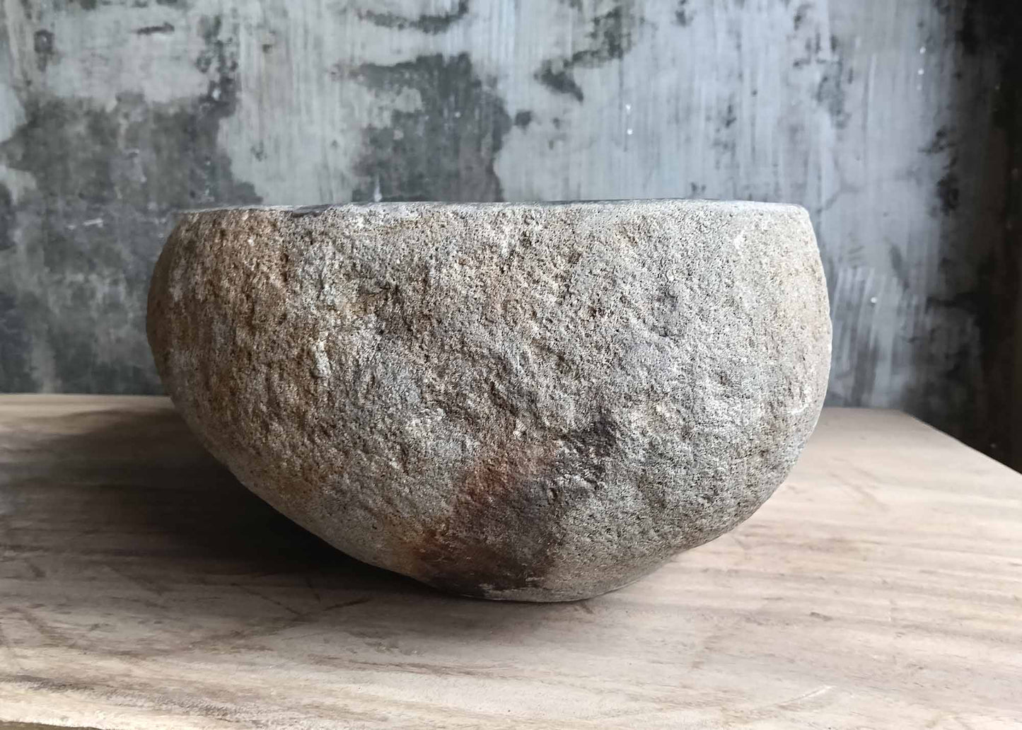 Left side of river stone sink with weathered organic stone pattern