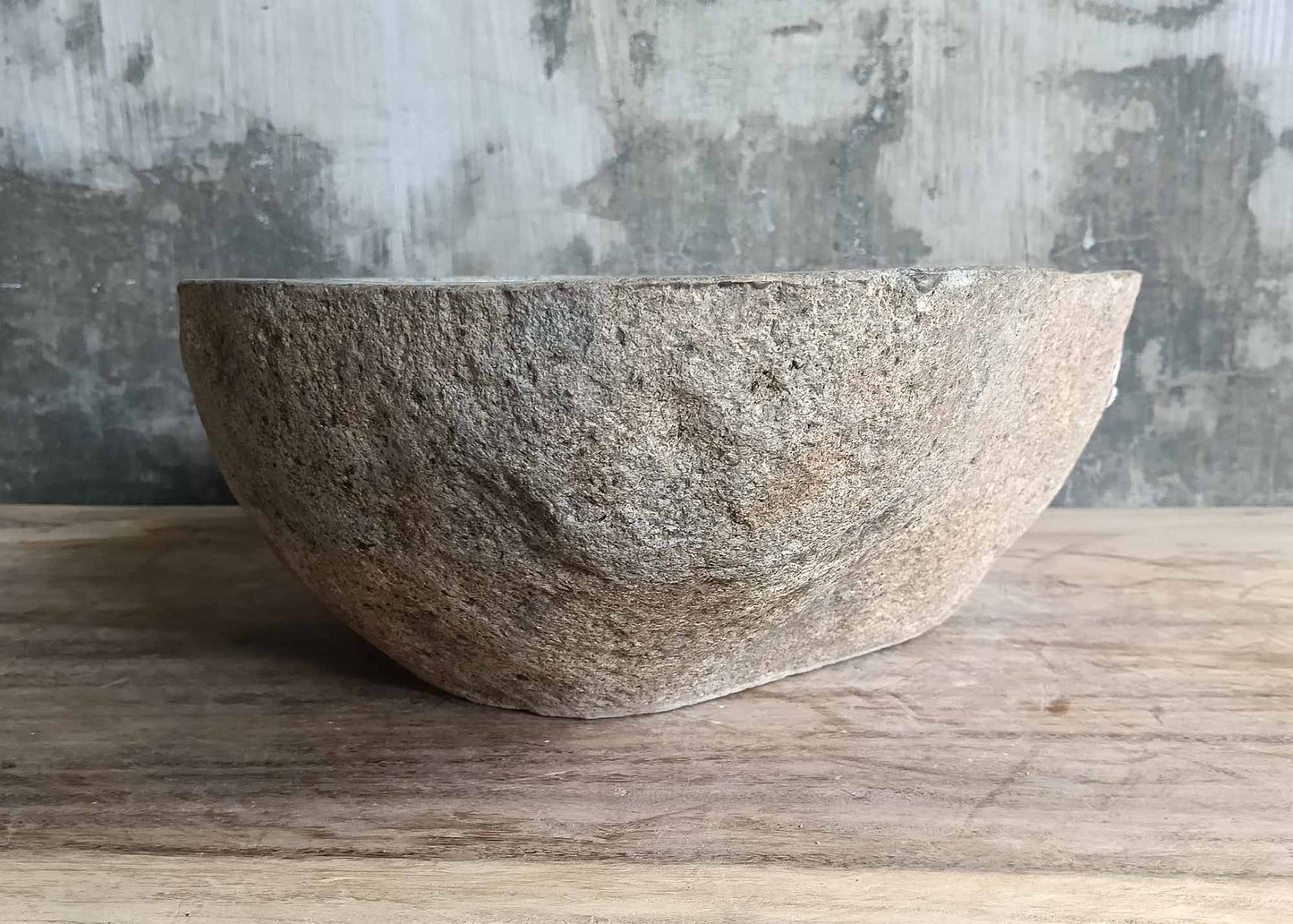 Right profile of rustic river sink showing warm stone pattern
