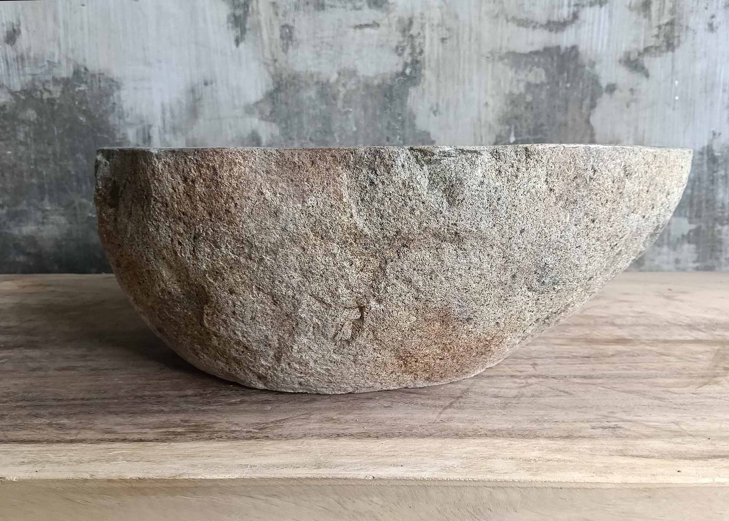 Left edge of polygonal stone sink with smooth inner contour
