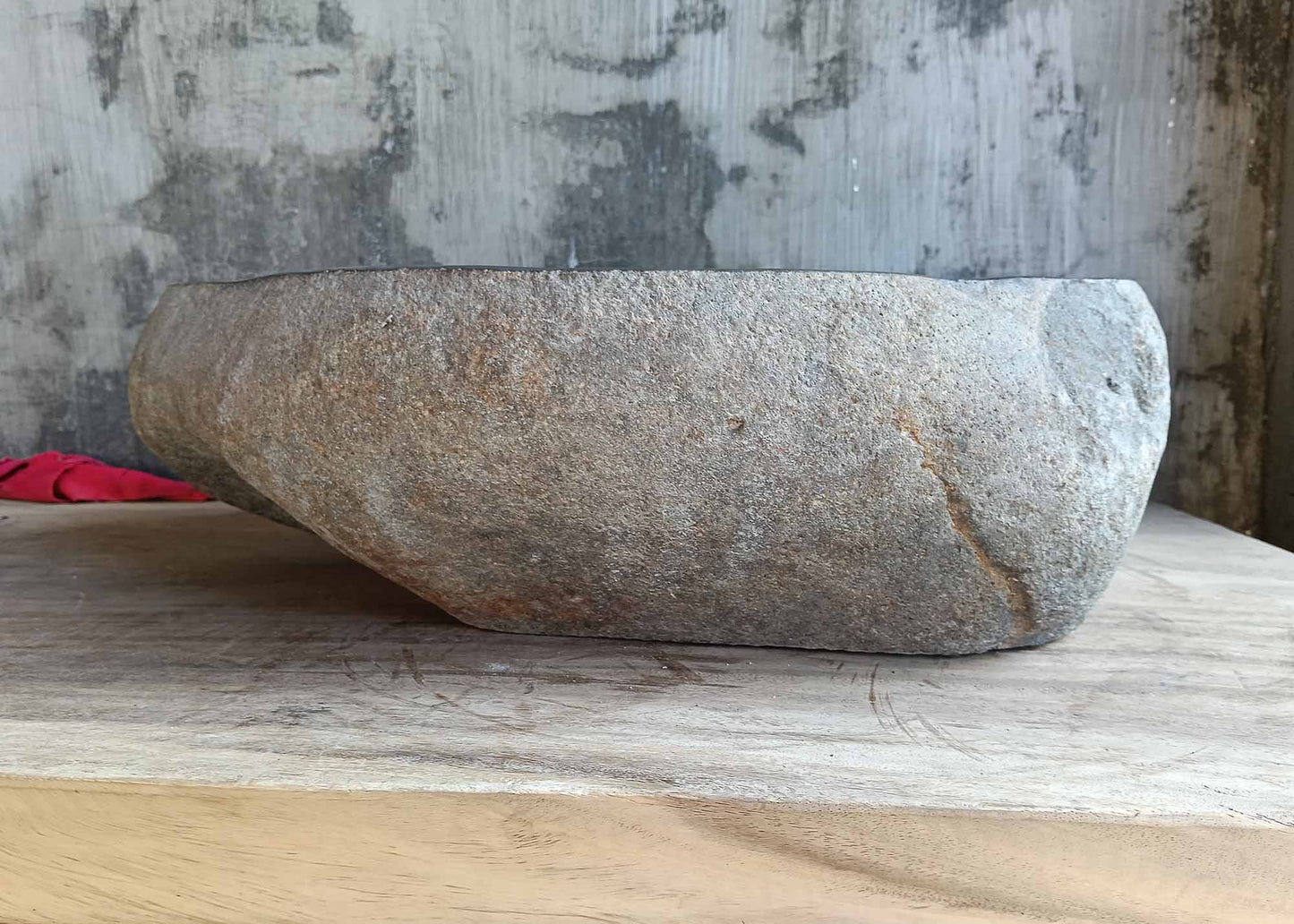 Natural stone sink showing raw back texture and curved contours – rear side