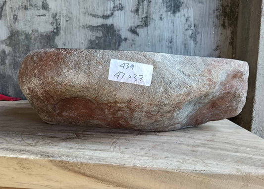 Handcrafted river stone sink with rugged brown-gray exterior – front perspective